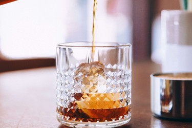 Fruit brandy being poured into a glass; Photo by StockSnap, Burst