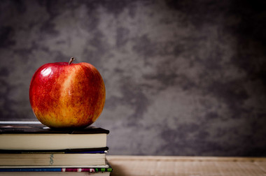 Apple on books; Photo by StockSnap, Michal Jamoluk