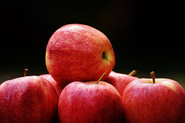 Red apples on black background; Photo by Pixabay