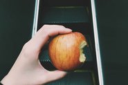 Hand holding apple; Photo by StockSnap, Saulo Zayas